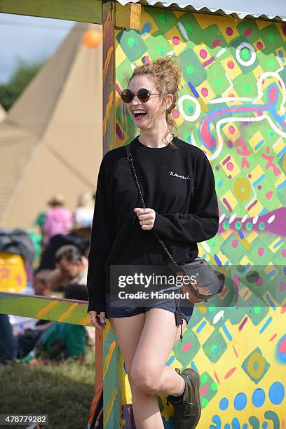 In this handout image supplied by Coach, Lily James wearing Coach attends the Glastonbury Festival at Worthy Farm, Pilton on June 26, 2015 in...