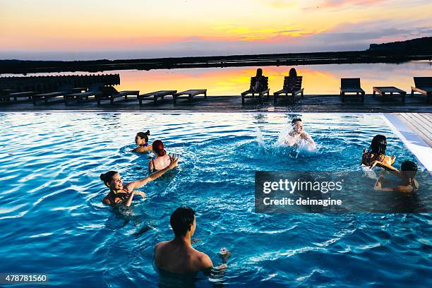 group of friends enjoying the pool party - pool party night stock pictures, royalty-free photos & images