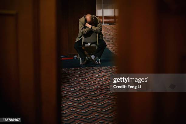 Chinese relative of the passenger onboard Malaysia Airlines flight MH370 sleeps after a briefing meeting for families at Lido Hotel on March 15, 2014...