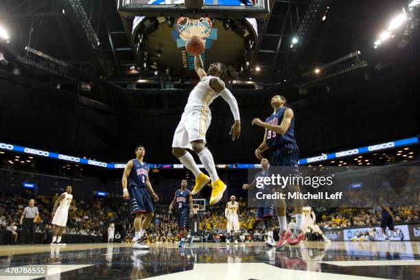 Forward Mo Alie-Cox of the VCU Rams dunks the ball against the Richmond Spiders in the Quarterfinals of the men's Atlantic 10 tournament on March 14,...