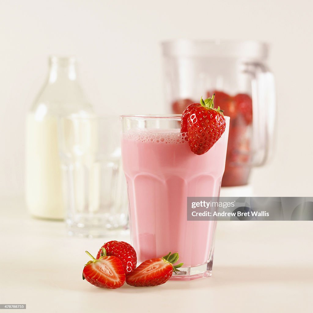 Freshly made strawberry milk shake and ingredients