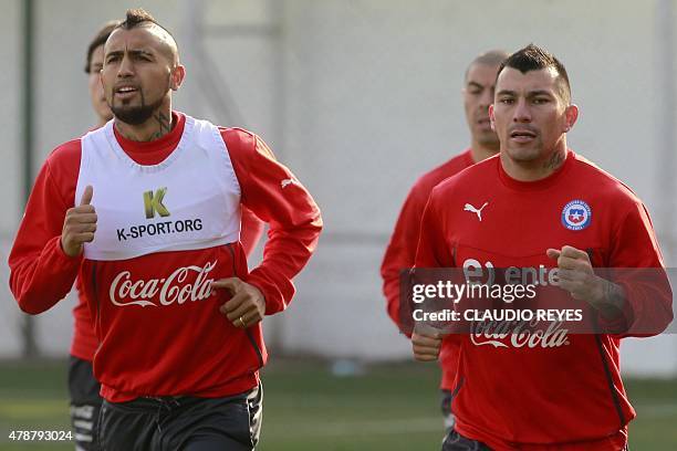 Chile's footballers Arturo Vidal and Gary Medel jog during a training session at the Juan Pinto Duran sports complex in Santiago, on June 27, 2015....