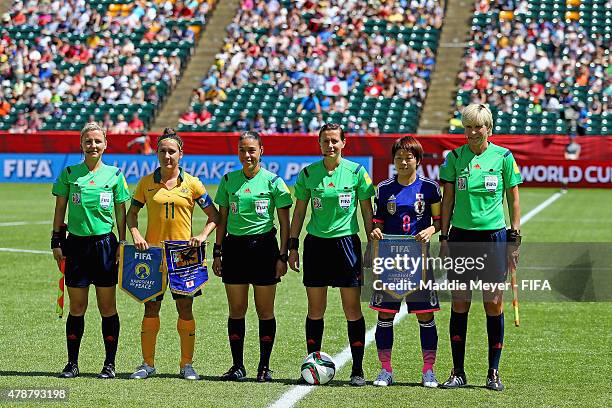 Lisa De Vanna of Australia and Aya Miyama of Japan stand with the referees before the FIFA Women's World Cup Canada 2015 quarter final match between...