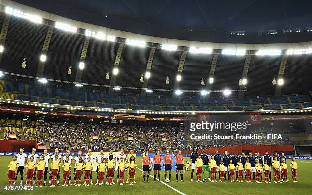 The teams line up the quarter final match of the FIFA Women's World Cup between Germany and France at Olympic Stadium on June 26, 2015 in Montreal,...