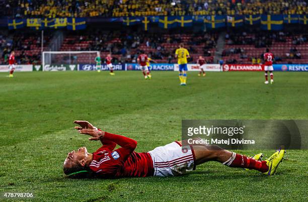 Yussuf Poulsen of Denmark lies injured during UEFA U21 European Championship semi final match between Denmark and Sweden at Generali Arena on June...