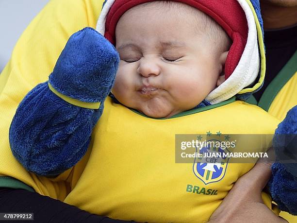 Baby with a Brazilian jersey is seen before the start of the 2015 Copa America football championship quarter-final match between Brazil and Paraguay,...