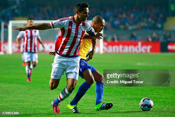 Roque Santa Cruz of Paraguay fights for the ball with Miranda of Brazil during the 2015 Copa America Chile quarter final match between Brazil and...