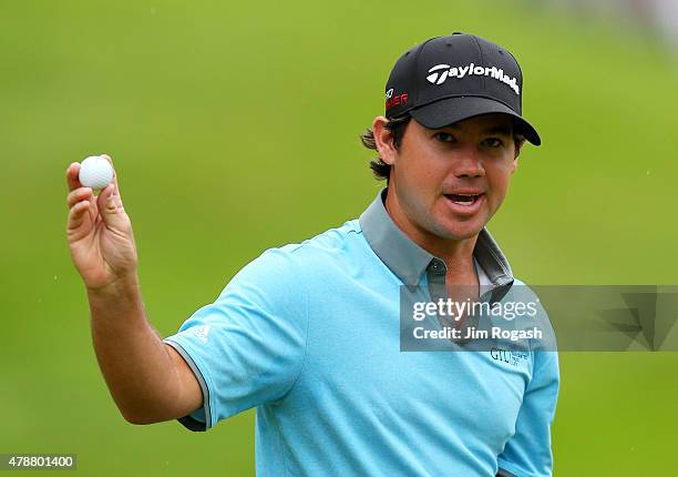 Brian Harman holds up his ball after finishing on the 18th green during the third round of the Travelers Championship at TPC River Highlands on June...