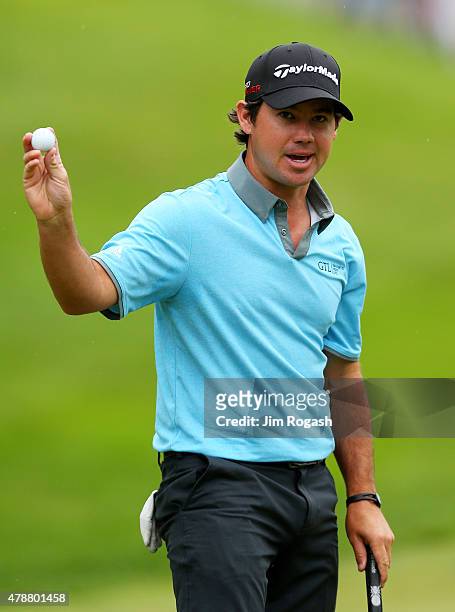 Brian Harman holds up his ball after finishing on the 18th green during the third round of the Travelers Championship at TPC River Highlands on June...