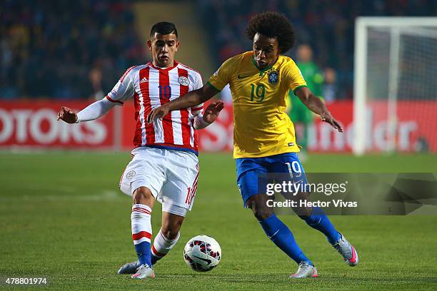 Willian of Brazil fights for the ball with Derlis Gonzalez of Paraguay during the 2015 Copa America Chile quarter final match between Brazil and...