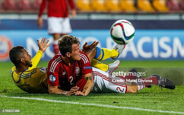 Alexander Scholz of Denmark battles for the ball with Isaac Kiese Thelin of Sweden during UEFA U21 European Championship semi final match between...