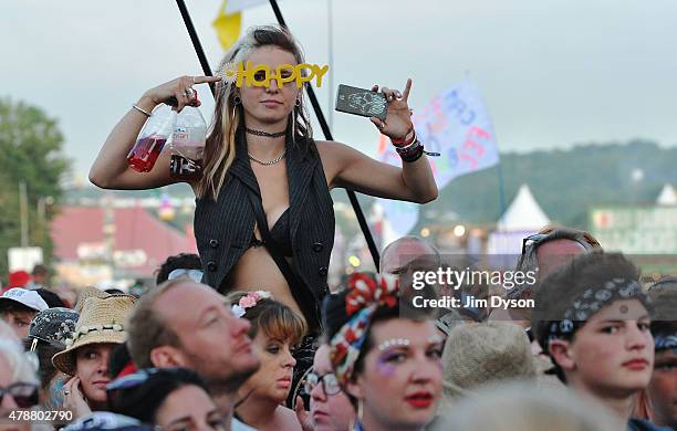 Music fan watches Pharrell Williams perform on the Pyramid stage during the second day of Glastonbury Festival at Worthy Farm, Pilton on June 27,...
