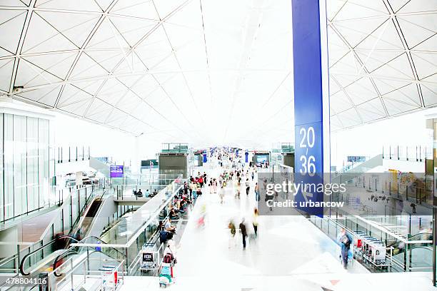 an airport interior, people travelling, motion blurred and high key - japan gate stock pictures, royalty-free photos & images