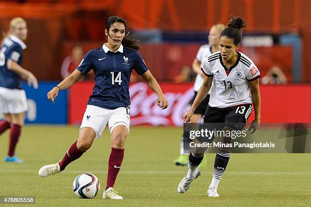 Louisa Necib of France looks to play the ball past Celia Sasic during the 2015 FIFA Women's World Cup quarter final match at Olympic Stadium on June...