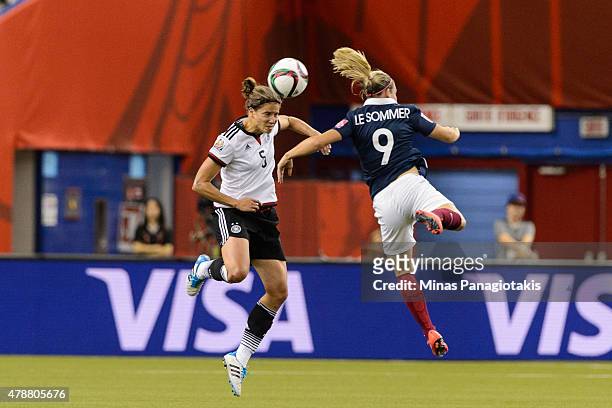 Annike Krahn of Germany and Eugenie Le Sommer of France jump for the ball during the 2015 FIFA Women's World Cup quarter final match at Olympic...