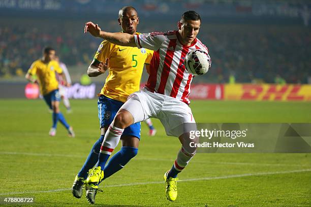 Raul Bobadilla of Paraguay fights for the ball with Fernandinho of Brazil during the 2015 Copa America Chile quarter final match between Brazil and...