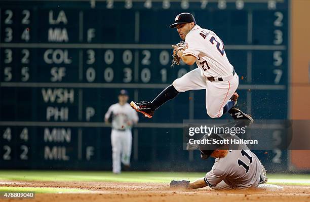 Jose Altuve of the Houston Astros cannot make a play on Brett Gardner of the New York Yankees at second base in the eighth inning during their game...
