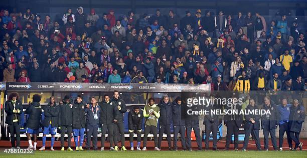 Brazilian coach Dunga watches the penalty kicks with his assistants and players during the 2015 Copa America football championship quarter-final...