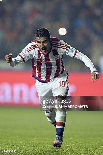 Paraguay's forward Derlis Gonzalez celebrates after scoring his penalty to defeat Brazil in the shoot-out of their 2015 Copa America football...