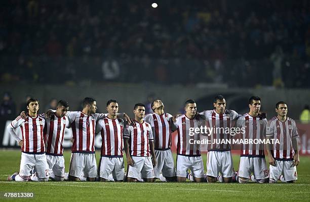 Paraguay's players kneel during the penalty shoot-out of their 2015 Copa America football championship quarter-final match against Brazil, in...