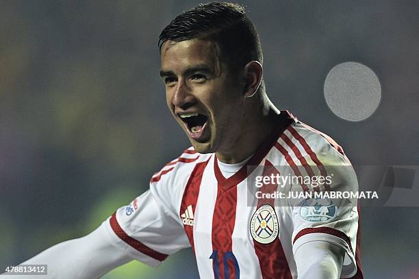 Paraguay's forward Derlis Gonzalez celebrates after scoring his penalty to defeat Brazil in the shoot-out of their 2015 Copa America football...