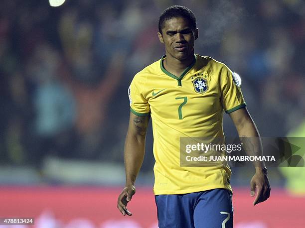 Brazil's midfielder Douglas Costa gestures after missing his penalty in the shoot-out of their 2015 Copa America football championship quarter-final...