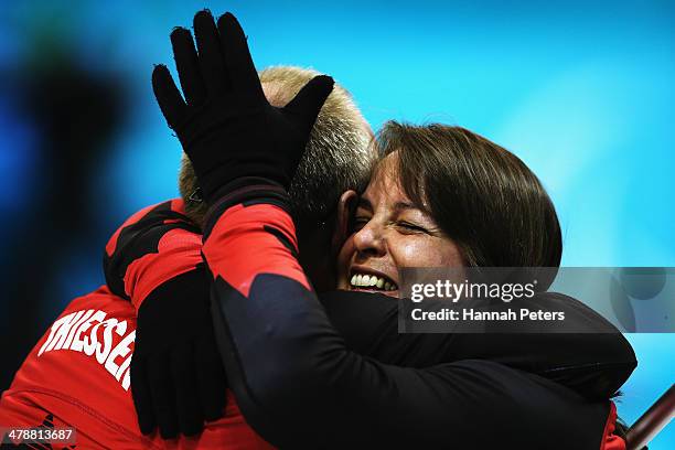 Dennis Thiessen of Canada celebrates with Ina Forrest after winning the semifinal match between China and Canada on day eight of Sochi 2014...