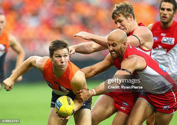 Toby Greene of the Giants is tackled by Jarrad McVeigh of the Swans during the round one AFL match between the Greater Western Sydney Giants and the...