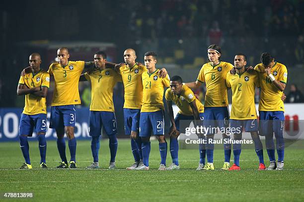 Players of Brazil look dejected in the penalty shootout during the 2015 Copa America Chile quarter final match between Brazil and Paraguay at Ester...