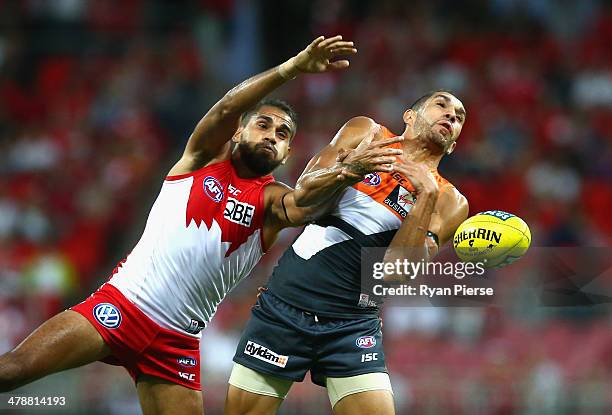 Lewis Jetta of the Swans competes for the ball against Curtly Hampton of the Giants during the round one AFL match between the Greater Western Sydney...