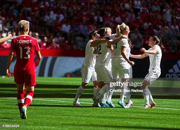 Steph Houghton celebrates teammate Karen Carney of England's goal against Canada during the FIFA Women's World Cup Canada 2015 Quarter Final match...