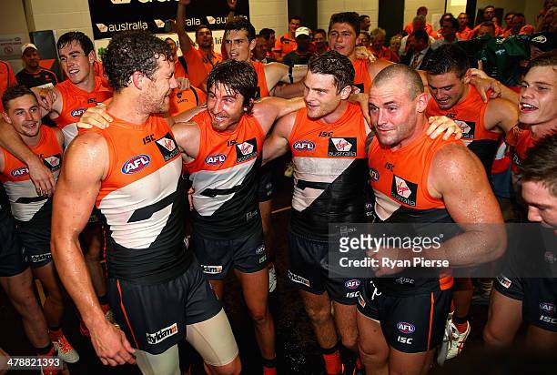 Shane Mumford, Dylan Addison, Heath Shaw and Josh Hunt of the Giants sing the club song after during the round one AFL match between the Greater...
