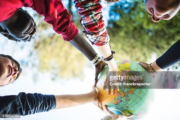 teenagers college student smiling with globe - wereldbol stockfoto's en -beelden