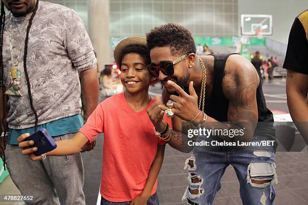 Singer Omarion takes a selfie with fan at the dance competition sponsored by King.com during the 2015 BET Experience at the Los Angeles Convention...