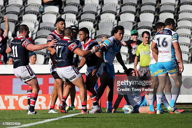 Michael Jennings of the Roosters celebrates with team mates after scoring a try during the round 16 NRL match between the Sydney Roosters and the...