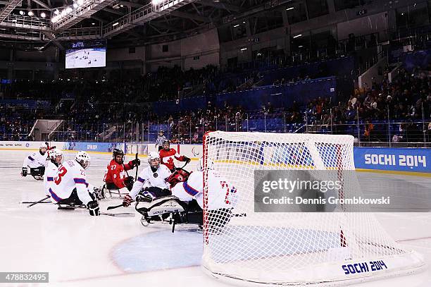 Brad Bowden of Canada scores his team's first goal during the ice sledge hockey bronze medal game between Canada and Norway at the Shayba Arena...