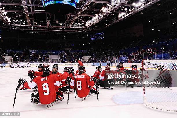 Canada players celebrate after the ice sledge hockey bronze medal game between Canada and Norway at the Shayba Arena during day eight of the 2014...