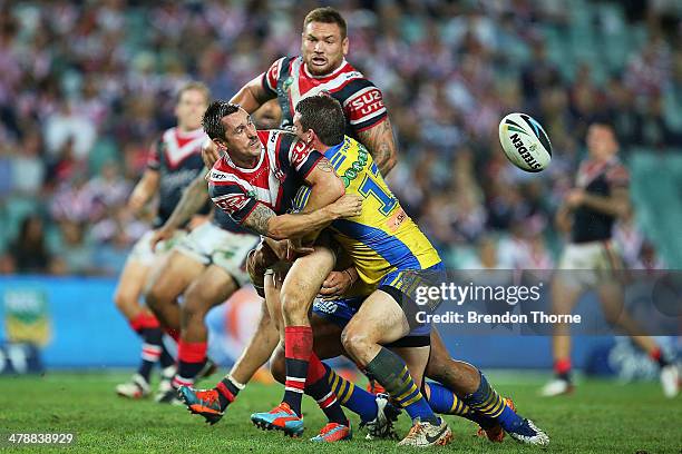 Mitchell Pearce of the Roosters offloads the ball to a team mate during the round two NRL match between the Sydney Roosters and the Parramatta Eels...