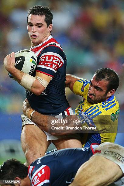 Daniel Mortimer of the Roosters is tackled by Tim Mannah of the Eels during the round two NRL match between the Sydney Roosters and the Parramatta...