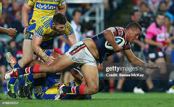 Kane Evans of the Roosters is tackled by Mitchell Allgood during the round two NRL match between the Sydney Roosters and the Parramatta Eels at...