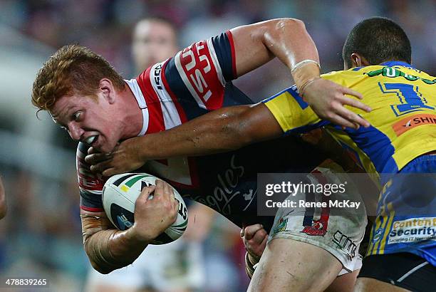 Dylan Napa of the Roosters is tackled by Joseph Paulo during the round two NRL match between the Sydney Roosters and the Parramatta Eels at Allianz...