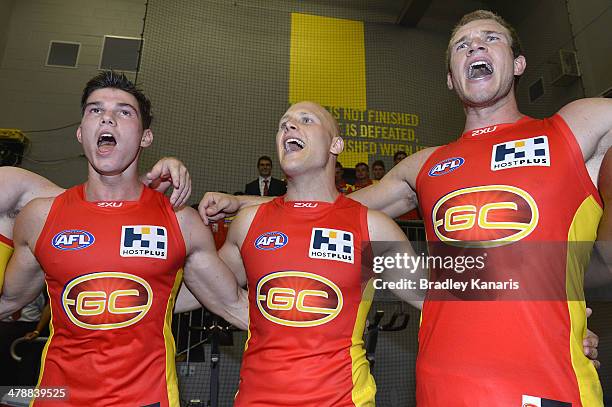 Jaeger O'Meara, Gary Ablett and Sam Day celebrate victory after the round one AFL match between the Gold Coast Suns and the Richmond Tigers at...