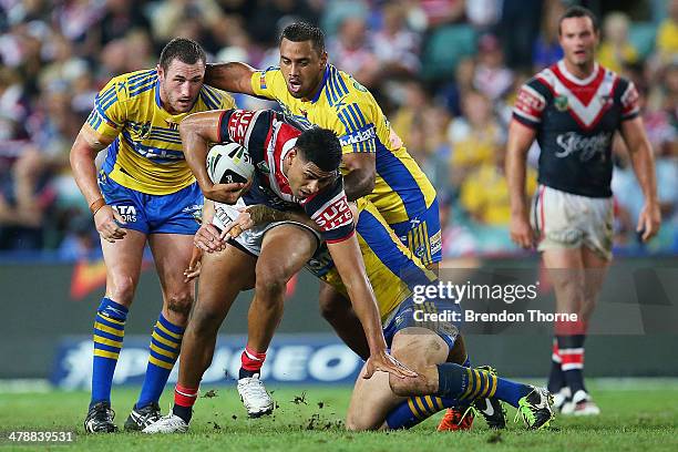 Daniel Tupou of the Roosters is tackled by the Eels defence during the round two NRL match between the Sydney Roosters and the Parramatta Eels at...