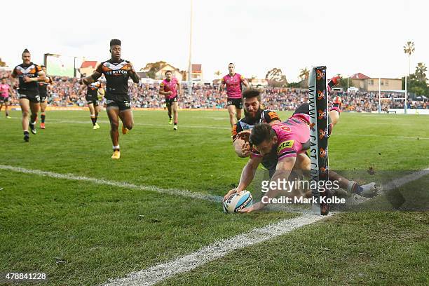 Josh Mansour of the Panthers scores a try during the round 16 NRL match between the Wests Tigers and the Penrith Panthers at Leichhardt Oval on June...