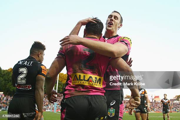 Josh Mansour of the Panthers is congratulated by Isaah Yeo of the Panthers after scoring a try during the round 16 NRL match between the Wests Tigers...