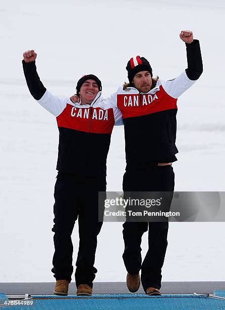 Gold medalist Mac Marcoux of Canada and guide Robin Femy celebrate during the flower ceremony for the Men's Giant Slalom Visually Impaired on day...