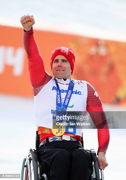 Christoph Kunz of Switzerland celebrates during the medal ceremony for the Men's Giant Slalom Sitting during day eight of the Sochi 2014 Paralympic...