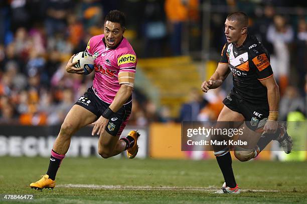 Dean Whare of the Panthers evades Kyle Lovett of the Wests Tigers during the round 16 NRL match between the Wests Tigers and the Penrith Panthers at...