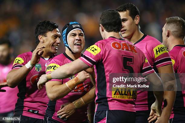 Jamie Soward and David Simmons of the Panthers celebrate after Simmons scored a try during the round 16 NRL match between the Wests Tigers and the...