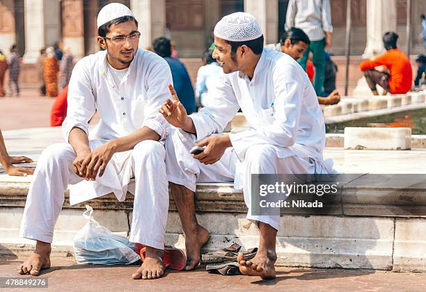 two men sitting at the jama masjid mosque, india - jama masjid agra stock pictures, royalty-free photos & images